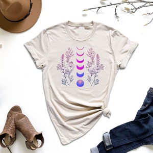 a t - shirt with a design on it next to a pair of jeans and