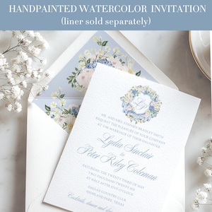 May include: Handpainted watercolor wedding invitation with floral details. The invitation features a light blue floral envelope liner and a matching invitation card with elegant script. The text reads "Lydia Sinclair to Peter Riley Coleman".