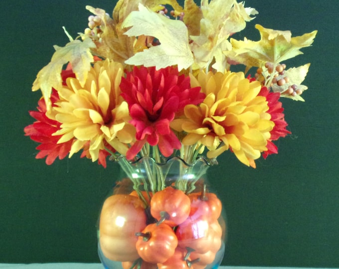 Fall Foliage, Red, Yellow and Orange Zinnia, Oak & Maple Leaves, in a light blue vase with mini pumpkins