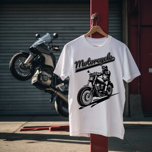 May include: White t-shirt with a black and white illustration of a motorcycle and the word "Motorcycle" in a black script font.