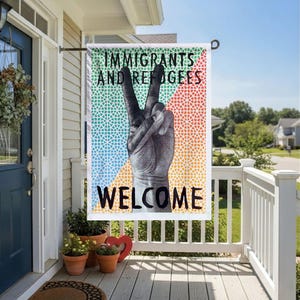 May include: A rectangular garden flag with the words "IMMIGRANTS AND REFUGEES WELCOME" in black text. The flag features a hand making a peace sign over a colorful background of green, blue, orange, and red.