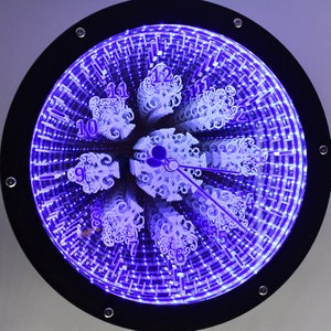 May include: A black framed clock with a mirrored face and purple LED lights. The clock face has a unique design with numbers 1-12 and a set of hands.