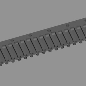 May include: A gray, rectangular harmonica comb with a series of rectangular openings and small circular holes. The comb is made of a solid material and has a uniform color. The design suggests a component for a musical instrument.