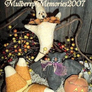 May include: A collection of handmade Halloween decorations, including a ghost, bat, candy corn, and jack-o'-lantern. The ghost wears a plaid scarf, and the bat has a purple bow. The candy corn is orange and yellow.