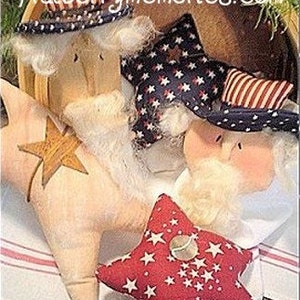 May include: A collection of patriotic star-shaped ornaments in a basket. The stars are in red, white, and blue, with some featuring Uncle Sam-style hats. One star has a wooden star accent, and another is covered in white stars.