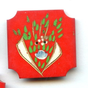 May include: Two red, square-shaped wooden boxes with rounded corners, one open, and a penny. The top box has a painted design of green leaves, white accents, and a blue flower. The bottom box is plain with two holes.