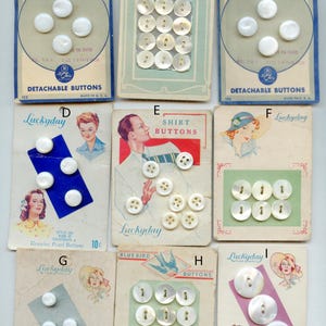 May include: A collection of nine vintage cardboard display cards featuring various white mother-of-pearl buttons. Each card displays different button counts and styles, with some cards showing illustrations of people and brand names like Sweet-Water Pearl and Luckyday.