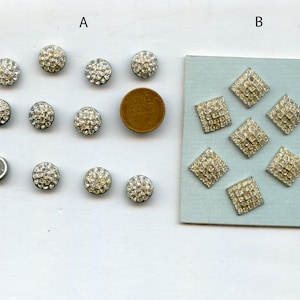 May include: Group A features ten round silver-tone buttons encrusted with clear rhinestones, displayed alongside a copper one-cent coin for scale. Group B consists of six square silver-tone buttons with clear rhinestones on a light blue card.