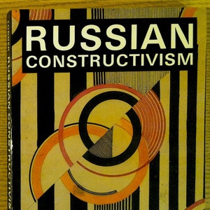 May include: Book cover with the title "RUSSIAN CONSTRUCTIVISM" in white text on a black background. The cover features a geometric design with overlapping circles in black, orange, and red on a yellow background with black stripes.