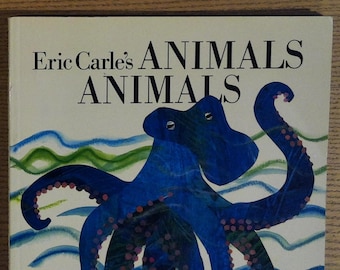 May include: A book cover featuring a blue octopus with pink spots swimming in a blue and green ocean. The book title is "Eric Carle's ANIMALS ANIMALS".