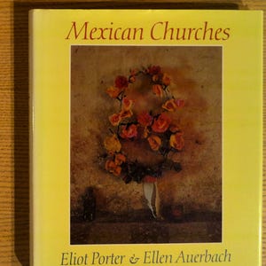 May include: A book titled "Mexican Churches" with a yellow cover. The cover features a photograph of a floral arrangement with red and orange roses. The authors' names, Eliot Porter & Ellen Auerbach, are printed at the bottom.