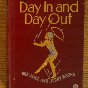May include: Vintage book cover titled "Day In and Day Out" in yellow lettering on a maroon background. The cover features a yellow illustration of a child with an umbrella. The text "THE ALICE AND JERRY BOOKS" is also present.
