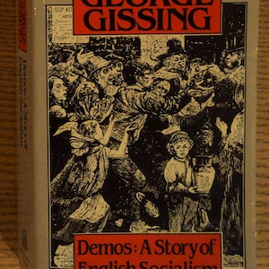 May include: A hardcover book titled "Demos: A Story of English Socialism" by George Gissing. The cover features a black and white illustration of a crowd of people. The title and author's name are in red boxes.