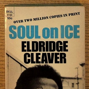 May include: A book cover with the title "Soul on Ice" by Eldridge Cleaver. The cover features a black and white photo of a man with a serious expression. The text "Over Two Million Copies in Print" is printed at the top of the cover.