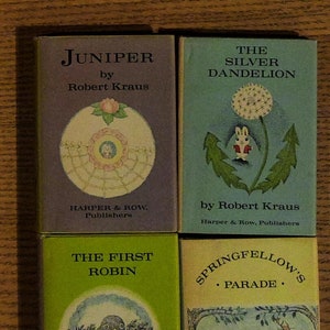 May include: Four vintage children's books by Robert Kraus. The covers feature illustrations of a juniper berry, a dandelion, a robin, and a deer with a rabbit. The titles are "Juniper", "The Silver Dandelion", "The First Robin", and "Springfellow's Parade".