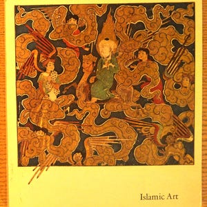 May include: A book cover featuring a detailed illustration of figures surrounded by swirling golden clouds against a dark blue background. The central figure wears a green robe and a halo. The text Islamic Art is printed in the bottom right corner.