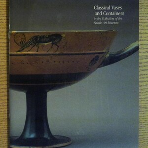 May include: A book cover featuring a black and brown ceramic vase with a black and white deer design. The title of the book is "Classical Vases and Containers in the Collection of the Seattle Art Museum."
