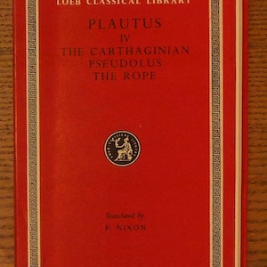 May include: A red hardcover book titled Loeb Classical Library Plautus IV The Carthaginian, Pseudolus, The Rope, translated by P. Nixon. The cover features a white geometric border and a circular logo with a seated figure in the center.
