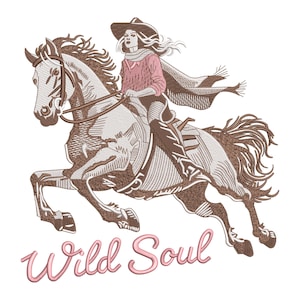 May include: An embroidered design of a person riding a horse, with the text "Wild Soul" in a cursive font. The rider wears a cowboy hat, scarf, and pink shirt. The horse is brown and white, with detailed stitching.