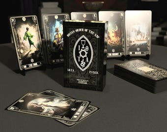 May include: A black and gold tarot deck box with the text "Ionian Order of the Asp" and "LO.TA. P.V.SCN."  The box is surrounded by tarot cards with images of The Fool, The Magician, The Hermit, and Death.