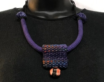 Hand Dyed Hand Woven Square Pendant Necklace with Ceramic Bead and Leather Lacing Closure in Blues and Purples