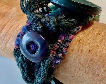 Handwoven Fiesta Loom Bracelet With Large Dark Green Wooden Button and Vintage Purple Button in Purples, Dark Greens and Color Mix Yarns