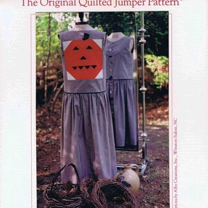May include: A sewing pattern for a quilted jumper with a pumpkin design on the front. The pattern is called "BOO! The Original Quilted Jumper Pattern." It includes sizes small, medium, and large. The pattern is from the Thread Bare Pattern Company.