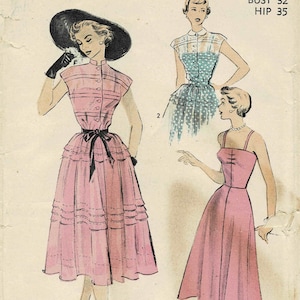 May include: A vintage sewing pattern for a dress with two different styles. The first style is a pink dress with a black belt and a ruffled skirt. The second style is a pink dress with a simple skirt. The pattern is from Advance, pattern number 5545, size 14, bust 32, hip 35. The pattern is featured in Mademoiselle.