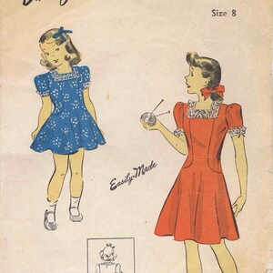 May include: A vintage sewing pattern for a girl's dress. The pattern is for size 8 and features two illustrations of girls wearing the dress. The dress is a simple, sleeveless style with a gathered skirt. The pattern is called "Perfect Pattern" and is from the brand "Du Barry".