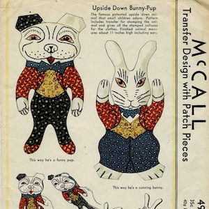 May include: A vintage McCall's pattern for a bunny and puppy doll. The pattern includes a transfer design with patch pieces. The pattern is for a 35 cent pattern and is 49 blue. The pattern is for a bunny and puppy doll that is 11 inches tall.