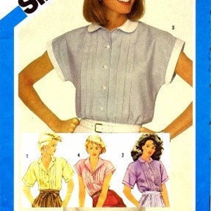 May include: Simplicity sewing pattern number 6410 for a collared blouse with short sleeves. The pattern includes instructions for making a variety of styles, including a classic button-up shirt, a ruffled blouse, and a blouse with a Peter Pan collar. The pattern is for sizes 8-20.