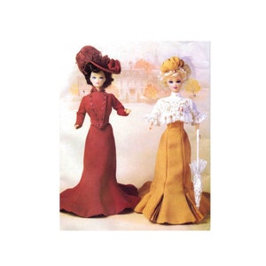 May include: Two vintage dolls wearing elegant dresses. The doll on the left is wearing a red dress with a matching hat. The doll on the right is wearing a yellow dress with a white lace top and a white parasol.