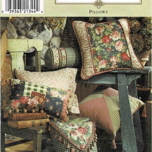 May include: A Simplicity Home pillow pattern with instructions for making five different pillows. The pillows feature a variety of fabrics, including floral, plaid, and gingham. The pattern includes instructions for making a pillow with a ruffled edge, a pillow with a tassel trim, and a pillow with a button closure.