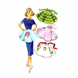 May include: A vintage illustration of a woman wearing a blue dress and a light blue apron with a heart-shaped pocket. Three additional aprons are shown: a green apron with white polka dots, a pink apron with white lace trim, and a white apron with a red ribbon and a green wreath.