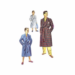 May include: Three people wearing robes. The person on the left is wearing a blue robe, the person in the middle is wearing a white robe, and the person on the right is wearing a red and black plaid robe.