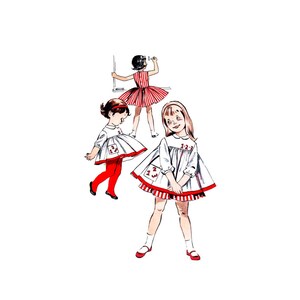 May include: Three girls wearing white dresses with red trim and red accents. The dresses have different designs, including a red and white striped trim, a red and white checkered trim, and a red and white polka dot trim. The girls are all smiling and looking at the camera.