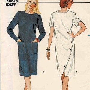 May include: Butterick sewing pattern 6359 featuring two dress designs. One dress is navy blue with long sleeves and pockets, the other is white with short sleeves and button details. The pattern includes size 12 and is labeled "Fast & Easy."