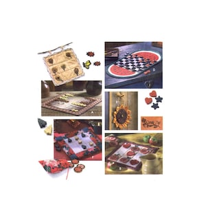 May include: A collection of handmade quilted game boards and pieces. The boards feature various themes, including a watermelon checkerboard, a sunflower, and a tic-tac-toe board. The pieces are made of wood and fabric and are painted in bright colors.