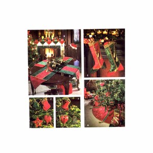 May include: A set of Christmas decorations featuring a red and green tree skirt, stockings, and ornaments. The decorations are made of fabric and feature a festive holiday theme.