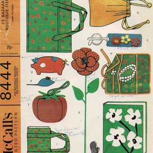 May include: A vintage sewing pattern for a variety of small items, including a tote bag, a flower, a piggy bank, a tomato, a glove, and a book. The pattern is printed on a yellow background with green, red, and white illustrations. The pattern number is 8444 and the title is "Time Saver Quickie".