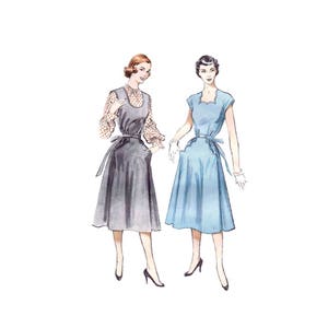 May include: Two women wearing dresses. The woman on the left is wearing a gray dress with a white blouse underneath. The woman on the right is wearing a light blue dress with a scoop neck.