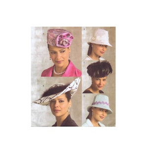 May include: Five different hat styles for women. The hats are in various colors and designs, including a pink hat with a flower, a white hat with a ribbon, a black hat with feathers, a white and black hat with feathers, and a light blue hat with a ribbon.