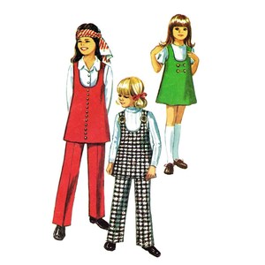 May include: Three girls wearing different outfits. The girl on the left is wearing a red jumpsuit with a white blouse underneath. The girl in the middle is wearing a black and white checkered jumpsuit with a white blouse underneath. The girl on the right is wearing a green dress with a white blouse underneath.