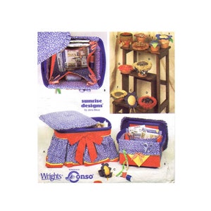 May include: A sewing pattern for making storage containers with a floral print fabric. The pattern includes instructions for making a lid, a base, and a skirt. The pattern is called "Sunrise Designs" by Jana Beus.