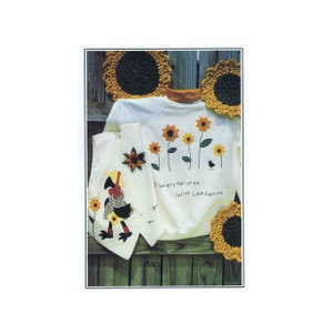 May include: A white sweatshirt with a design of sunflowers and a bird with the text "Flowers for thee. With Love from me". There are also two smaller white fabric pieces with a sunflower design and a design of a person with a sunflower hat.