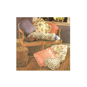 May include: A collection of decorative pillows in various patterns and colors, including floral, geometric, and solid designs. The pillows are arranged on a wooden bench with a wicker basket and a wooden stool.
