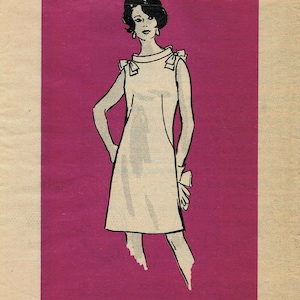 May include: A vintage sewing pattern for a sleeveless dress with a bow detail at the shoulders. The pattern is printed on a pink background and includes the number 4643 and size 18 1/2.