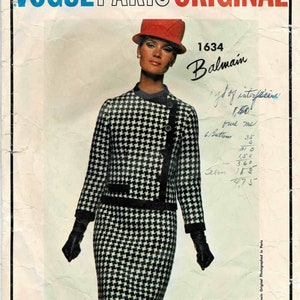 May include: A black and white houndstooth pattern dress and jacket set with a red hat. The pattern is a classic design. The set is from Vogue Paris Original and is designed by Balmain. The pattern number is 1634.