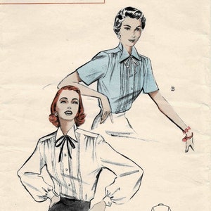 May include: Vintage sewing pattern for a women's blouse with a bow tie. The pattern is from Butterick and is number 5696. The pattern is for size 14 and bust 32. The pattern is printed and costs 45 cents.