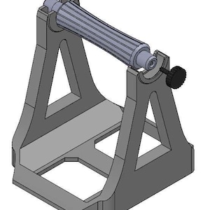 Può includere: Un dispositivo meccanico grigio renderizzato in 3D con un componente cilindrico scanalato tenuto all'interno di un telaio. Il telaio ha un design triangolare con una base rettangolare e una manopola nera sul lato. Il dispositivo sembra essere uno strumento o parte di una macchina.